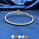 Close-up detail of 925 sterling silver bracelet showing baguette and emerald-cut cubic zirconia stones with rhodium plated finish and geometric sparkle design