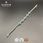 Close-up macro detail of 925 oxidised sterling silver bracelet showing star-shaped design, sky blue synthetic stones and sparkling marcasite craftsmanship in high detail