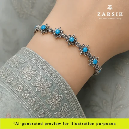 Elegant woman wearing Sky Blue Starlight 925 oxidised silver bracelet with sky blue stones and marcasite details, styled with chic outfit for everyday and evening wear