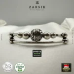 Close-up macro detail of 925 sterling silver beads and engraved centrepiece on dual-band bracelet highlighting fine Balinese craftsmanship