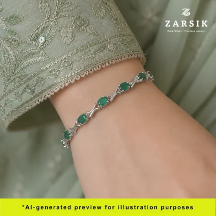A woman wearing a Genuine Emerald Silver Tennis Bracelet paired with an elegant dress for a sophisticated evening look.