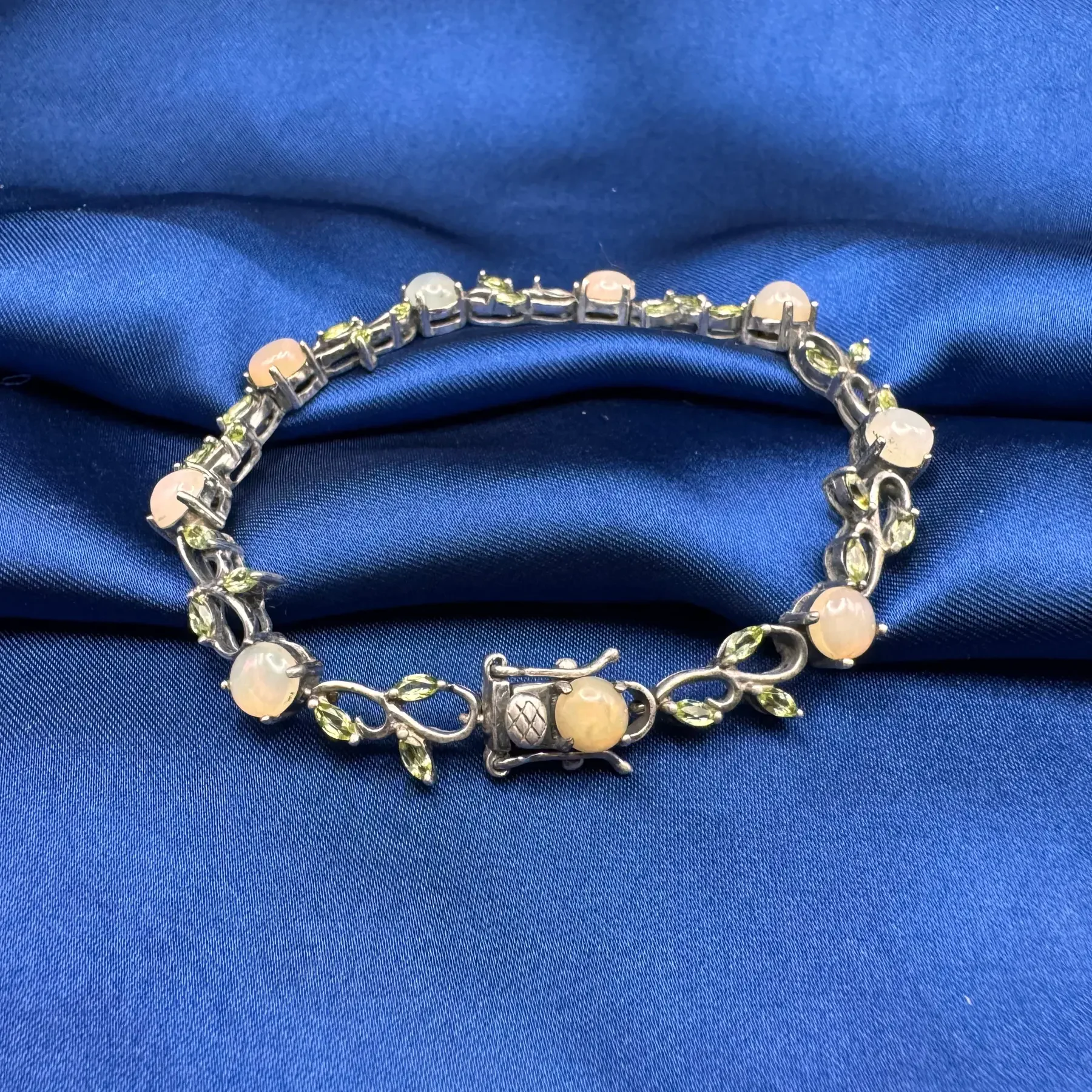BR015 925 Oxidised Silver Opal and Peridot Bracelet with leaf motifs, displayed at full length on a clean white background