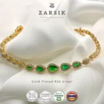 Radiant teardrop glow bracelet in gold plated 925 sterling silver with green stones on white background