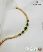 Radiant teardrop glow bracelet in gold plated 925 sterling silver with green stones on white background
