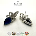 Elegant 925 sterling silver blue teardrop earrings with cubic zirconia accents and rhodium plating