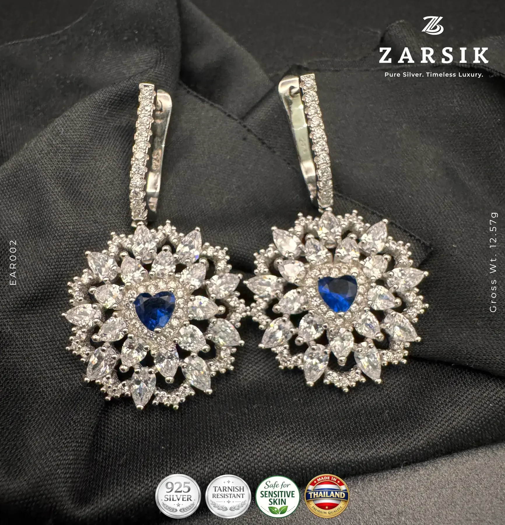 Radiant Floral Halo Earrings in 925 Sterling Silver Radiant floral halo earrings in 925 sterling silver with deep blue center stone and rhodium plated finish