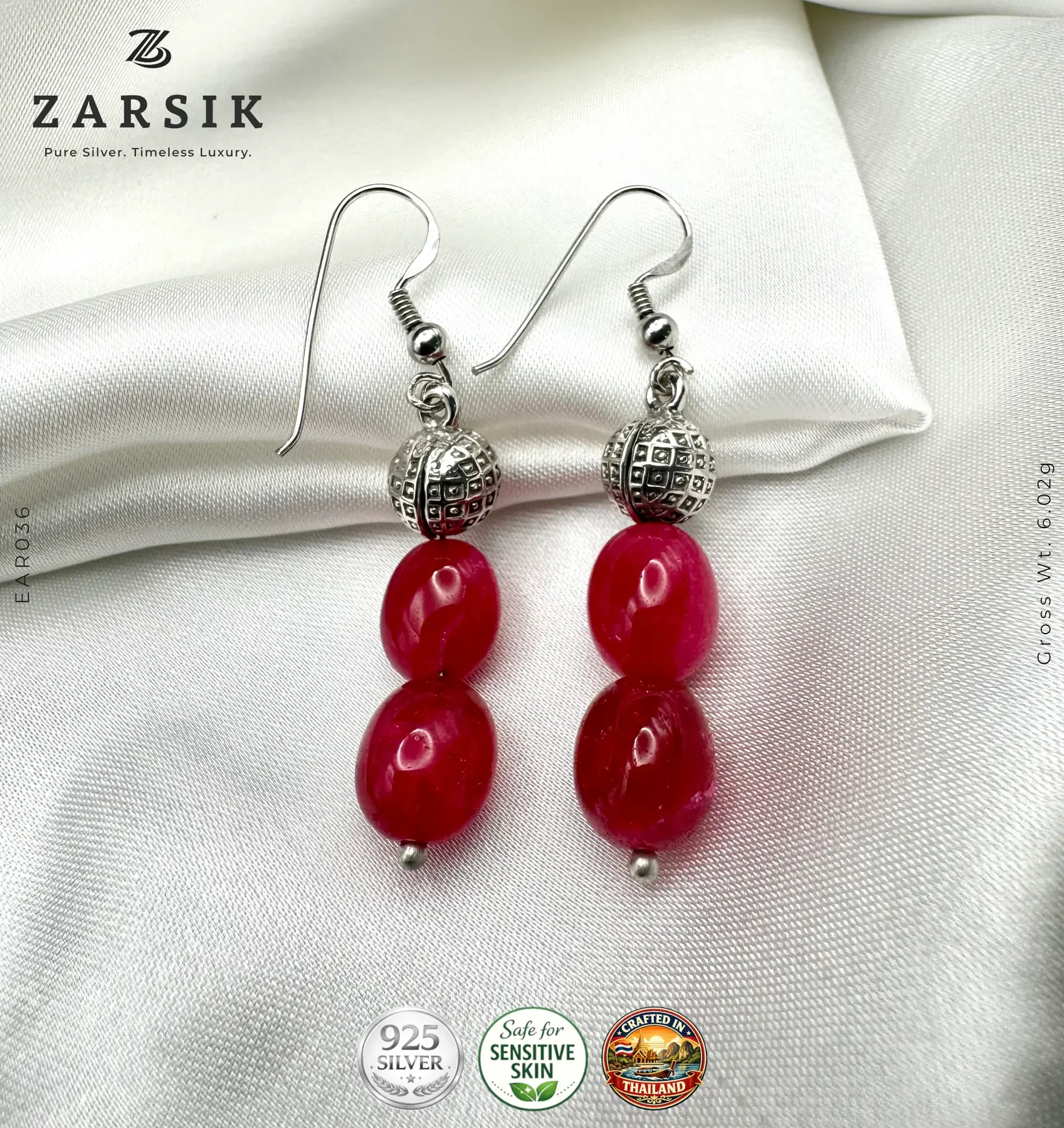 Handmade 925 Silver Dangle Earrings with Red Stones Pair of Handmade 925 Silver Dangle Earrings with oval red stones on a luxury soft background.