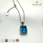 Close-up of rectangular synthetic blue stone pendant with Cubic Zirconia halo and rhodium plated silver chain