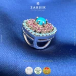 Close up of intricate Turkish metalwork and turquoise stones on rhodium plated 925 silver pendant