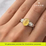 Elegant hand wearing 925 silver moissanite ring with light yellow centre stone in soft natural lighting