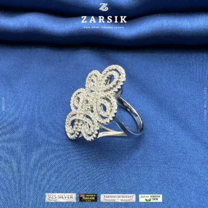 925 sterling silver cubic zirconia statement ring with rhodium plated floral design on white background