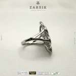 925 sterling silver cubic zirconia statement ring with rhodium plated floral design on white background