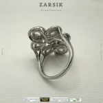 925 sterling silver cubic zirconia statement ring with rhodium plated floral design on white background