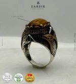 Close-up of oxidised 925 sterling silver men’s ring with engraved Turkish detailing and oval Tiger’s Eye gemstone
