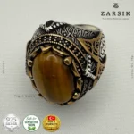Close-up of oxidised 925 sterling silver men’s ring with engraved Turkish detailing and oval Tiger’s Eye gemstone