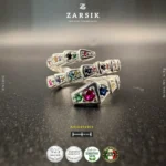 Close-up detail of pavé-set multi-colour Cubic Zirconia and synthetic gemstones on Rhodium-plated 925 silver serpentine spiral ring