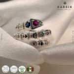 Adjustable 925 silver multi-gemstone serpentine spiral ring in Rhodium-plated finish on plain background
