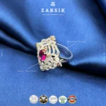 Close-up macro view of 925 sterling silver statement ring showing cubic zirconia halo, coloured centre stone, and rhodium plated finish details