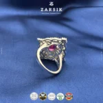 925 sterling silver statement ring with coloured centre stone and cubic zirconia halo, rhodium plated jewellery close-up