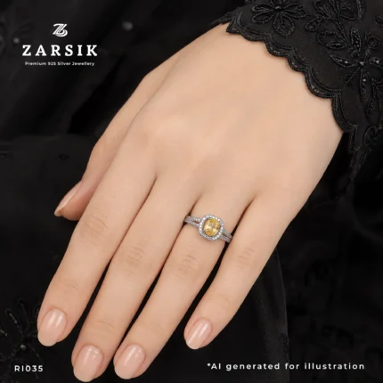 Women's golden topaz 925 silver ring with a cubic zirconia halo, worn on the ring finger in an elegant lifestyle jewellery photograph.
