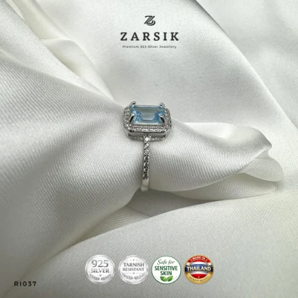 Radiant Blue Topaz Halo Ring crafted in 925 sterling silver with emerald-cut blue topaz and cubic zirconia halo