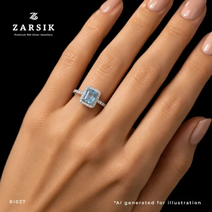 Woman wearing a radiant blue topaz halo ring in 925 sterling silver with sparkling cubic zirconia accents