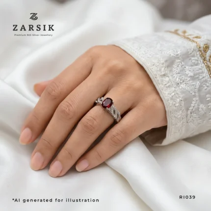 Woman wearing a Majestic Garnet 925 Silver leaf ring featuring a natural oval garnet and elegant cubic zirconia accents
