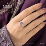 Elegant woman wearing a Majestic Purple Amethyst 925 Silver solitaire ring with an oval-cut amethyst and sparkling cubic zirconia, styled for everyday luxury and special occasions.