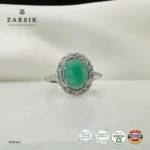 Emerald Ring crafted from authentic 925 Silver featuring a natural oval-cut emerald, sparkling cubic zirconia halo, rhodium plating and elegant shoulder detailing.